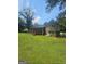 The home's expansive backyard includes a screened-in porch and a well-kept lawn at 7562 Asbury Manor, Lithonia, GA 30058