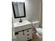 Modern bathroom featuring a sleek vanity with a stylish black faucet and a bright, well-lit mirror at 7562 Asbury Manor, Lithonia, GA 30058