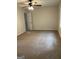 Large carpeted bedroom with a ceiling fan, ample natural light, and a view of the doorway at 7562 Asbury Manor, Lithonia, GA 30058