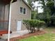 The home's exterior features a back door leading to a small patio area and a fenced in backyard at 7562 Asbury Manor, Lithonia, GA 30058