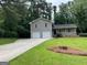 Charming two-story home with a well-manicured lawn and a long, paved driveway at 7562 Asbury Manor, Lithonia, GA 30058