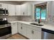 Modern kitchen features white cabinets, stainless steel appliances, and attractive countertops at 7562 Asbury Manor, Lithonia, GA 30058