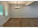 An empty living room with light gray walls, modern lighting, and beautiful laminate flooring at 7562 Asbury Manor, Lithonia, GA 30058