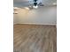 An empty living room with light gray walls, modern lighting, and beautiful laminate flooring at 7562 Asbury Manor, Lithonia, GA 30058