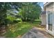 Large, private backyard with lush greenery and mature trees, creating a serene outdoor space at 686 Shore Ln, Lithonia, GA 30058