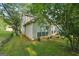 View of backyard featuring manicured lawn and exterior home at 686 Shore Ln, Lithonia, GA 30058