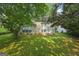 A sprawling, grassy backyard with mature trees and a patio area, perfect for outdoor enjoyment at 686 Shore Ln, Lithonia, GA 30058