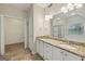 Bathroom with double sinks, granite counters, white cabinets, and a separate shower and tub at 686 Shore Ln, Lithonia, GA 30058