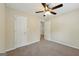 Bedroom features neutral walls, carpet, lighting and interior door at 686 Shore Ln, Lithonia, GA 30058