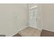 Bright foyer featuring tile flooring, a transom window, and a white front door at 686 Shore Ln, Lithonia, GA 30058