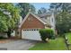 Two-story home featuring a brick facade, a two-car garage, and a well-maintained lawn at 686 Shore Ln, Lithonia, GA 30058