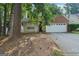 Charming home with a two-car garage and partially obscured by mature trees at 686 Shore Ln, Lithonia, GA 30058