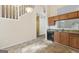Kitchen area showcasing tiled floors and oak cabinets with a view of the staircase at 686 Shore Ln, Lithonia, GA 30058
