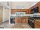 Well-lit kitchen featuring granite countertops, stainless steel appliances, and tile flooring at 686 Shore Ln, Lithonia, GA 30058