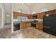 Well-equipped kitchen with a view of the living room, wood cabinets, and modern appliances at 686 Shore Ln, Lithonia, GA 30058