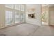 Bright living area featuring a carpet, an abundance of windows, and neutral colored walls at 686 Shore Ln, Lithonia, GA 30058