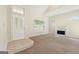 Inviting living room with a fireplace, large windows, and neutral carpet at 686 Shore Ln, Lithonia, GA 30058