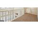 Loft boasts natural light from windows with railing overlooking lower level at 686 Shore Ln, Lithonia, GA 30058