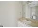 Bright bathroom featuring a white vanity with a light marble countertop and large mirror at 4738 Golod Way, Lithonia, GA 30038
