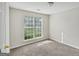 Cozy bedroom featuring soft carpet, white walls, and a window offering natural light at 4738 Golod Way, Lithonia, GA 30038