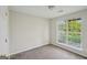 Light-filled bedroom with neutral carpet, window, and white walls, providing a serene space at 4738 Golod Way, Lithonia, GA 30038