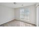 Bright bedroom featuring a large window with blinds and neutral-toned walls and carpet at 4738 Golod Way, Lithonia, GA 30038