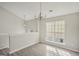 Charming dining room with wood-look flooring, decorative lighting, and lots of natural light from the large window at 4738 Golod Way, Lithonia, GA 30038