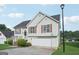 Well-maintained home with light siding, attached garage, landscaping, and red shutters that add a touch of color at 4738 Golod Way, Lithonia, GA 30038