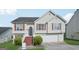 Charming two-story home featuring light siding, red shutters, an attached garage, and well-maintained landscaping at 4738 Golod Way, Lithonia, GA 30038