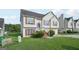 Two-story home featuring light siding, red shutters, an attached garage, and a spacious front yard at 4738 Golod Way, Lithonia, GA 30038