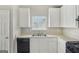 Compact kitchen with white cabinets, a double sink, and ample counter space at 4738 Golod Way, Lithonia, GA 30038