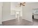 Open-concept living room featuring wood-look flooring and neutral walls, with a view of the stairway and kitchen at 4738 Golod Way, Lithonia, GA 30038