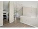 Open-concept living space with high ceilings, wood flooring, leading to a kitchen and living room with a fireplace at 4738 Golod Way, Lithonia, GA 30038