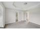 Spacious bedroom with a tray ceiling and doorways leading to an ensuite bathroom at 4738 Golod Way, Lithonia, GA 30038