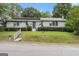 Inviting single-story home featuring a well-maintained lawn and charming curb appeal at 4705 Ernest Dr, Forest Park, GA 30297