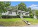 View of the home's exterior with green grass and a staircase that leads to the front door at 4705 Ernest Dr, Forest Park, GA 30297