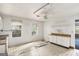 Kitchen features white cabinets, a sink, windows and a ceiling fan at 4705 Ernest Dr, Forest Park, GA 30297