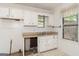 Kitchen featuring white cabinets, sink, and a window providing natural light at 4705 Ernest Dr, Forest Park, GA 30297