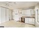 A kitchen with white cabinets, a sink, a back door and two windows at 4705 Ernest Dr, Forest Park, GA 30297