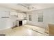 A kitchen with white cabinets, a sink, two windows, and a ceiling fan at 4705 Ernest Dr, Forest Park, GA 30297