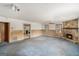 A spacious living area featuring paneling and an impressive stone fireplace, creating a warm and inviting space at 4705 Ernest Dr, Forest Park, GA 30297