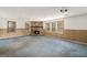 Spacious living room featuring paneling and a striking stone fireplace, perfect for cozy evenings at 4705 Ernest Dr, Forest Park, GA 30297