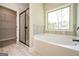 Bathroom features a large soaking tub and window with natural lighting at 6005 Crowley Dr, Douglasville, GA 30135