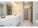 Bright bathroom featuring double vanity with framed mirror and walk-in closet at 6005 Crowley Dr, Douglasville, GA 30135
