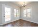 Bright dining room featuring hardwood floors, two large windows, and access to a deck at 6005 Crowley Dr, Douglasville, GA 30135