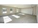 A spacious garage with concrete flooring, windows for natural light, and a white door at 6005 Crowley Dr, Douglasville, GA 30135