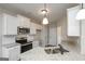 Modern kitchen featuring white cabinets, stainless steel appliances, and granite countertops at 6005 Crowley Dr, Douglasville, GA 30135