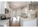 Open kitchen with stainless steel appliances, granite counters, and an adjacent dining area at 6005 Crowley Dr, Douglasville, GA 30135