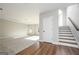 Spacious living room featuring stairs, hardwood flooring, neutral carpeting and natural light at 6005 Crowley Dr, Douglasville, GA 30135