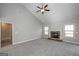 Spacious living room with a cozy stone fireplace, vaulted ceilings, and neutral carpet at 6005 Crowley Dr, Douglasville, GA 30135